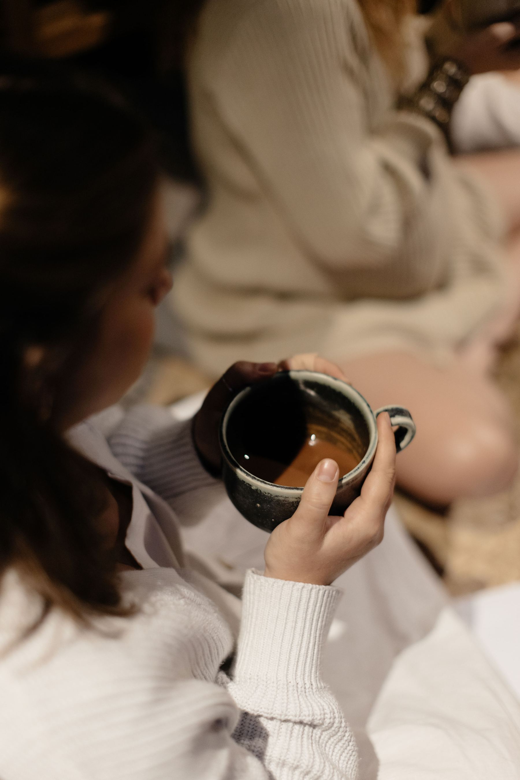 Woman holding tea cup in ceremony