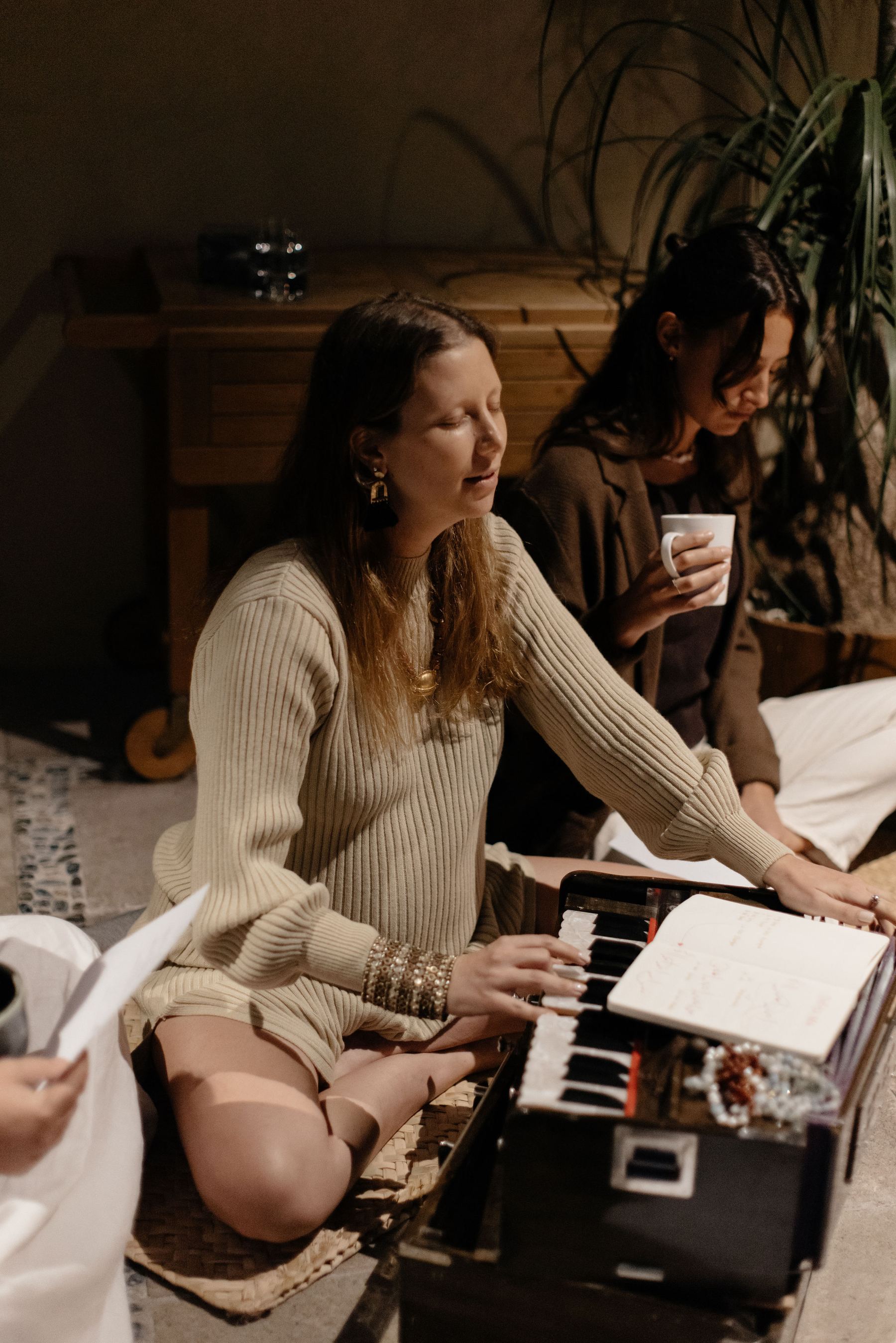 Ana playing harmonium in ceremony